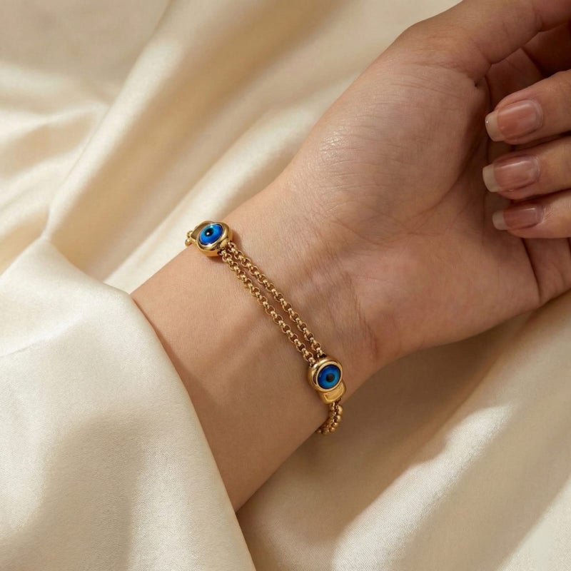 A stylish gold bracelet made of rust-resistant stainless steel, with two interlocking chains and a double "blue eye" design for a modern look, with an adjustable clasp to fit you. - Image 3